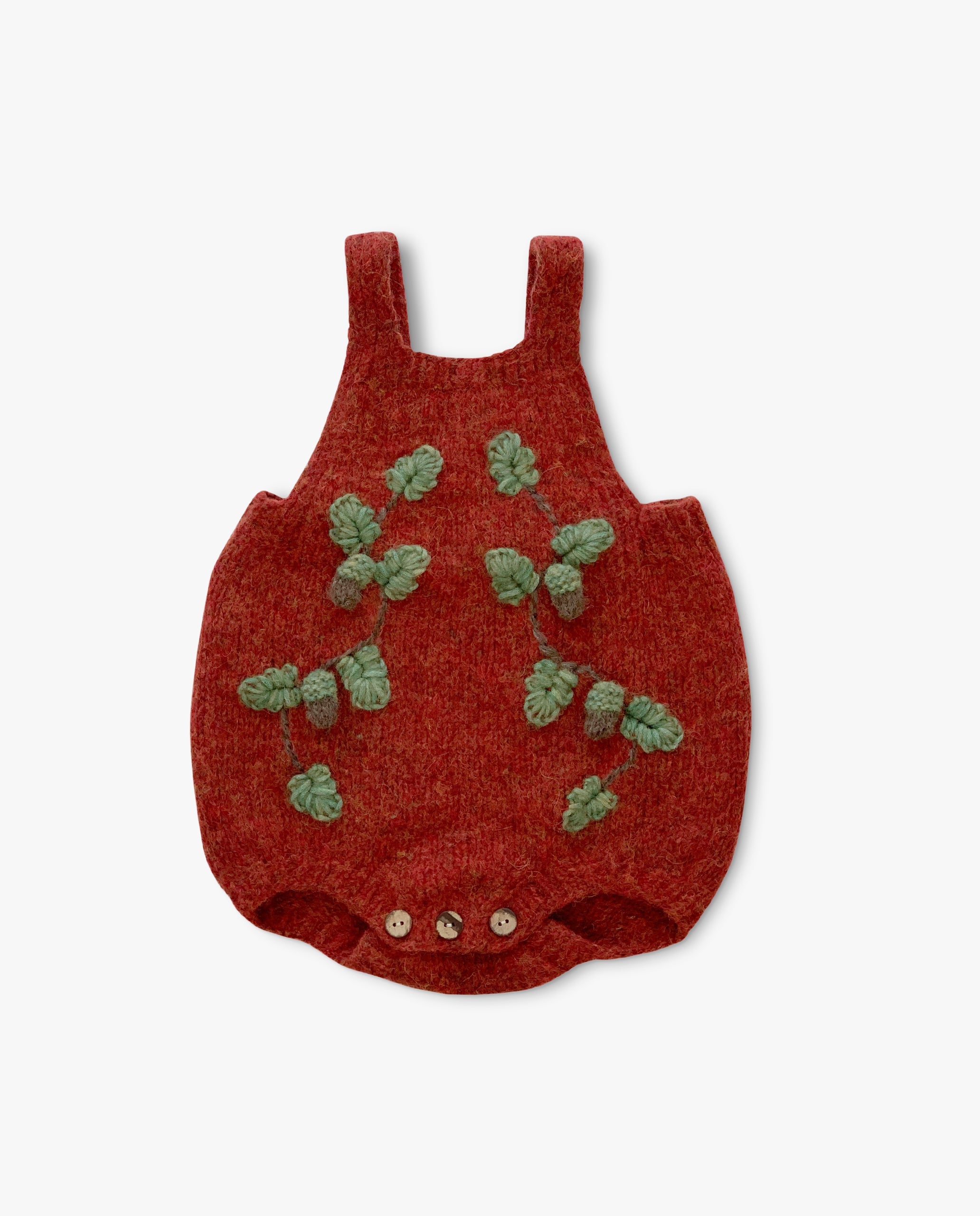 Red baby romper with green leaf patterns on a white background