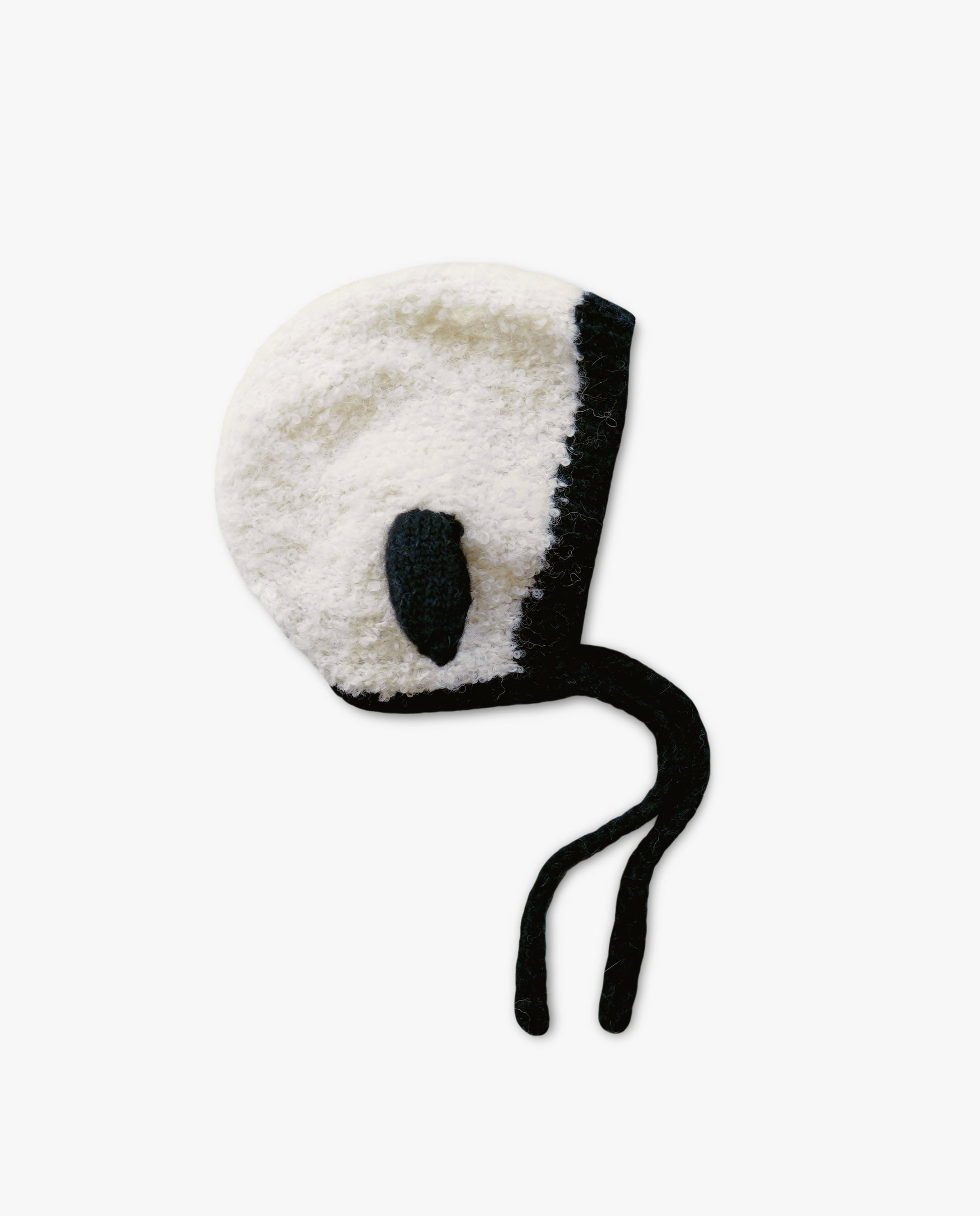White baby bonnet with black trim on a white background