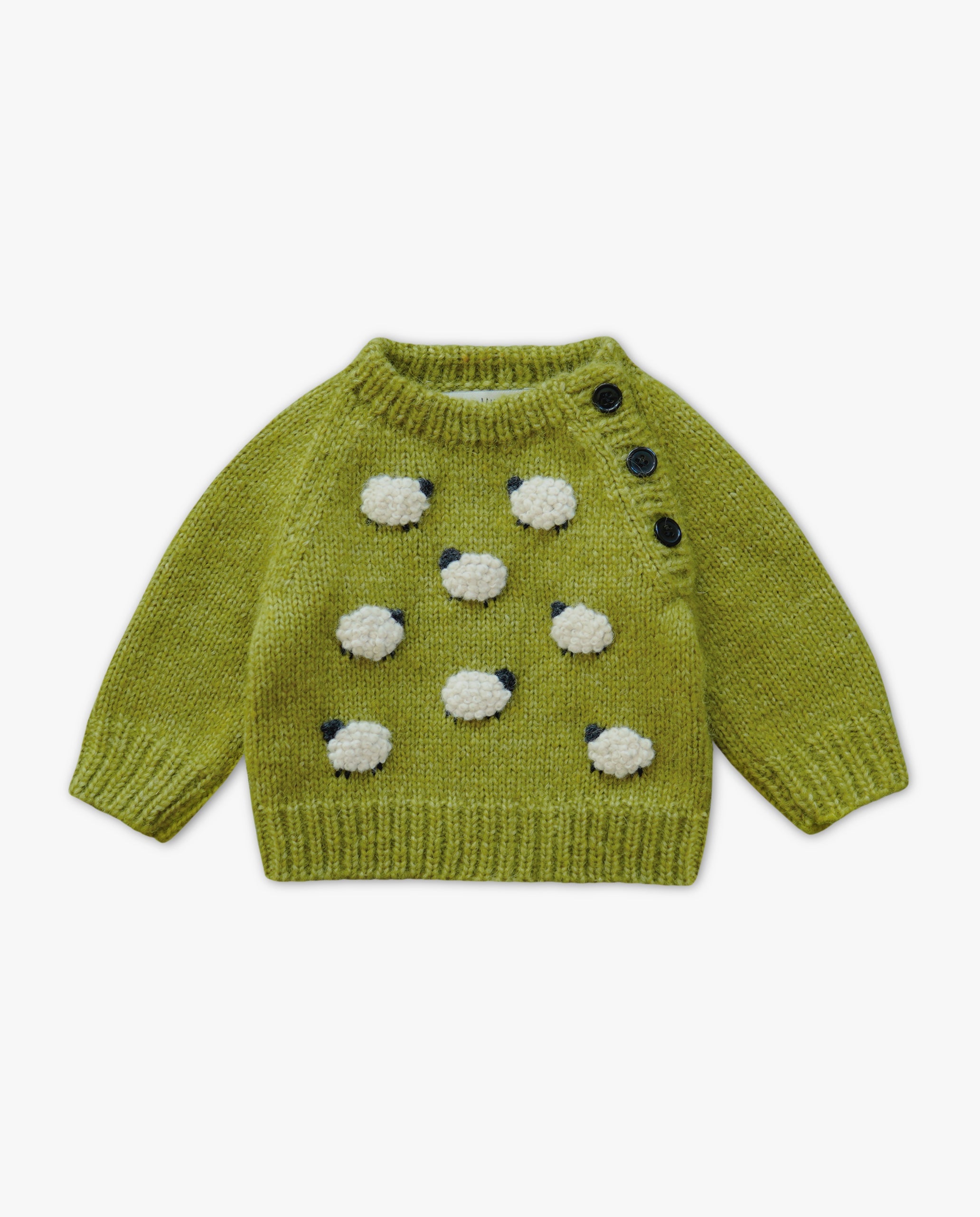 Green knitted sweater with sheep designs on a white background